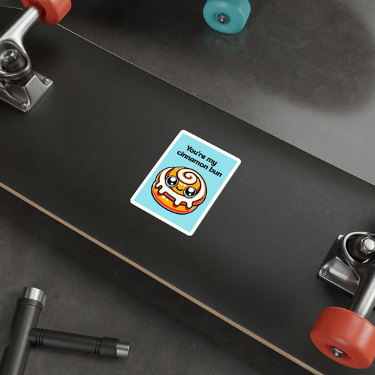 A whimsical sticker depicting a kawaii-style cinnamon bun with a caption "You&
