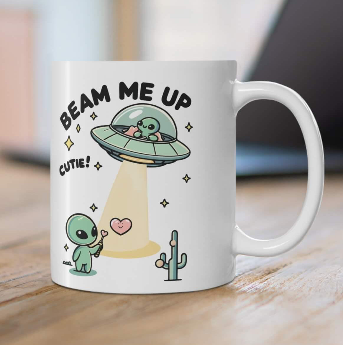 Fun and playful white ceramic mug with alien illustrations and the cheeky text 'Beam Me Up, Cutie!,' giving your morning a cosmic lift
