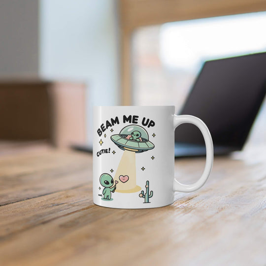 Fun and playful white ceramic mug with alien illustrations and the cheeky text 'Beam Me Up, Cutie!,' giving your morning a cosmic lift