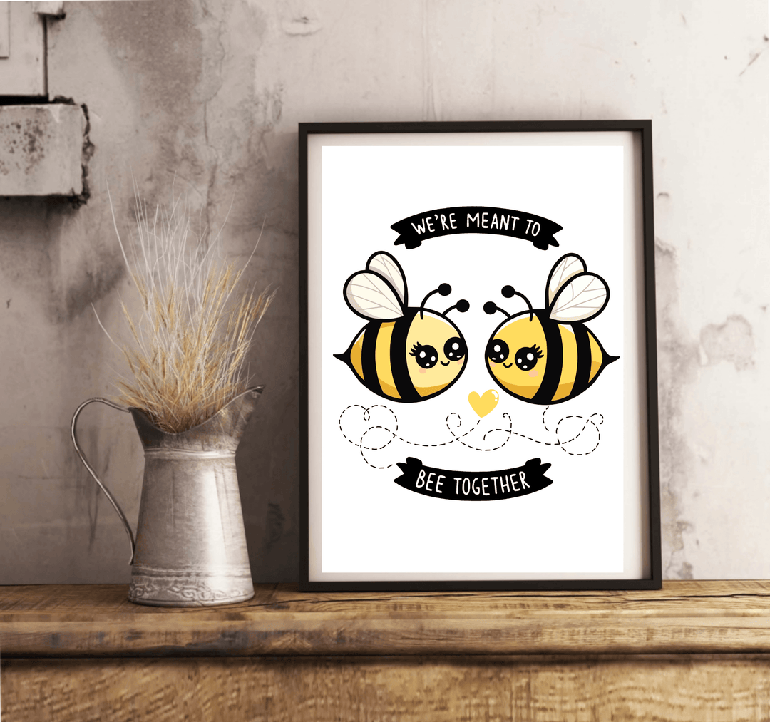 Introducing our charming "We're Meant to Bee Together" print! This delightful piece features two adorable cartoon bees, complete with cute, smiling faces, on a crisp white background. A heart and playful dotted lines connect the bees, beautifully symbolizing unity and togetherness. The sweet message, "We're meant to bee together," makes this print a perfect addition for anyone looking to add some nature-themed warmth to their home decor. Whether you’re sprucing up your living space or searching for a though