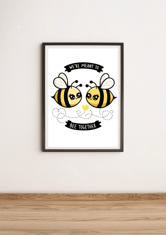 Introducing our charming "We're Meant to Bee Together" print! This delightful piece features two adorable cartoon bees, complete with cute, smiling faces, on a crisp white background. A heart and playful dotted lines connect the bees, beautifully symbolizing unity and togetherness. The sweet message, "We're meant to bee together," makes this print a perfect addition for anyone looking to add some nature-themed warmth to their home decor. Whether you’re sprucing up your living space or searching for a though