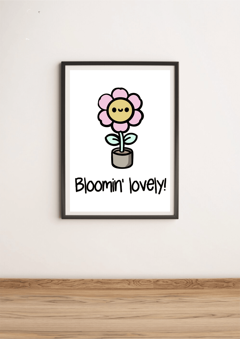 Introducing the "Bloomin' Lovely Print" – a delightful touch of British charm that's sure to bring a smile to your face! This adorable cartoon-style flower showcases a cheerful pink bloom with the happiest little face, all nestled in its cozy gray pot. The playful phrase "Bloomin' lovely!" dances beneath it, capturing the essence of positivity and growth. Perfectly placed on a light wooden floor against a crisp white wall, this print is just waiting to brighten up your space with its whimsical vibe.