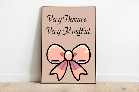 Welcome to a charming scene featuring the delightful framed print, "Very Demure, Very Mindful." Nestled on a cozy wooden floor against a pristine white wall, this artwork beautifully captures attention with its enchanting phrase: "Very Demure. Very Mindful." The design boasts an oversized, stylized pink bow adorned with a darker pink center and graceful ribbon accents, all set against a soothing beige background. Perfect for adding a touch of elegance and tranquility to any space!