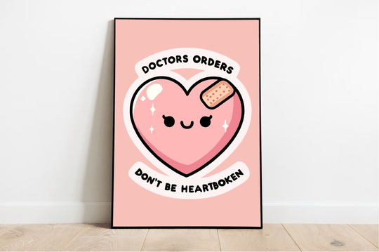 Brighten up your space with a touch of whimsy! Against a crisp white wall and nestled on a warm wooden floor, our charming "Doctor's Orders: Don't Be Heartbroken" Print is sure to catch your eye. Featuring an adorable illustration of a smiling pink heart adorned with a tiny bandage, this piece simply radiates cheer. The text playfully reminds us: "Doctor's orders, don't be heartbroken." Its soft pink background makes it the perfect addition to your gallery wall. Add some love and smiles to any room!