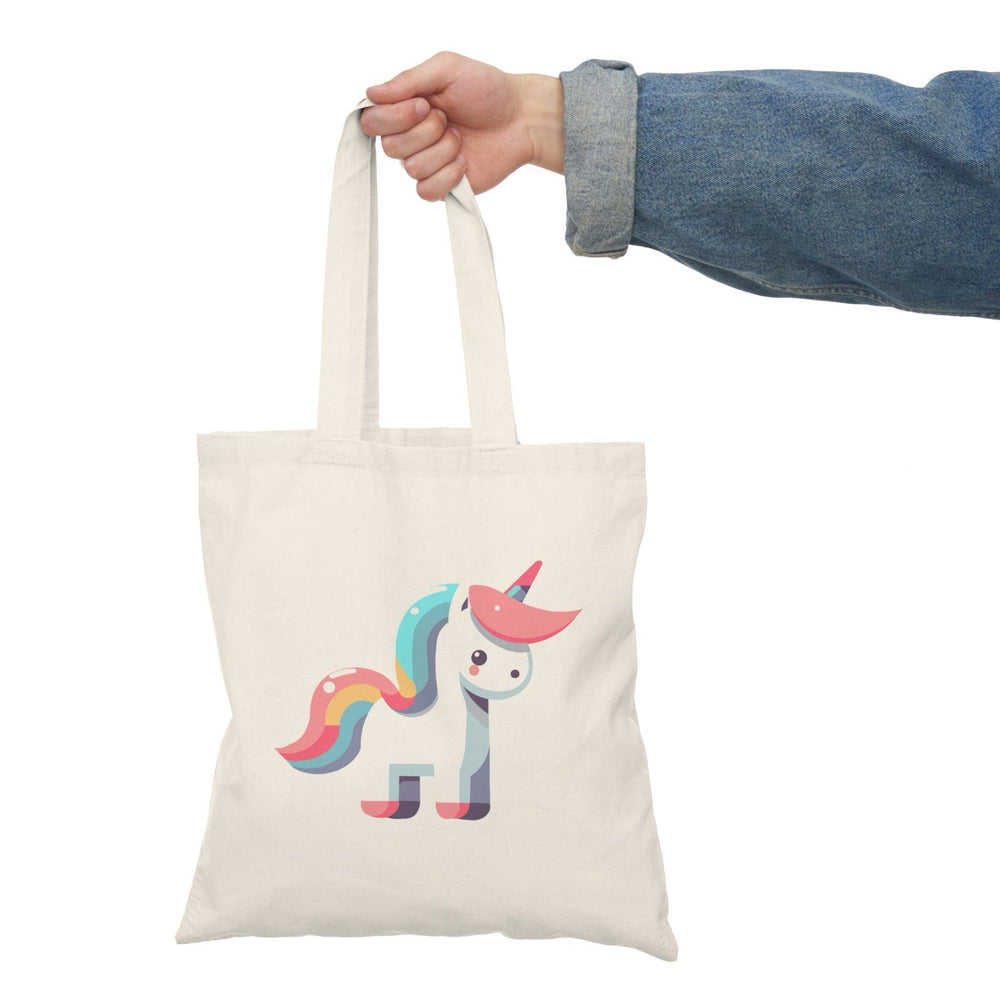 A natural canvas tote bag featuring a vibrant illustration of a colorful unicorn. The whimsical design adds a touch of magic and fantasy, making it an enchanting accessory for unicorn enthusiasts and dreamers.