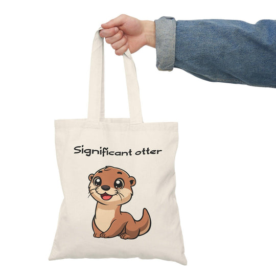 A cream tote bag featuring an adorable illustration of a smiling otter with the text 'Significant Otter.' The cute design celebrates love and companionship, perfect for animal lovers and those who enjoy puns.