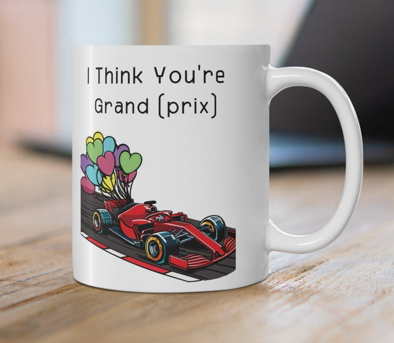 White ceramic mug with a colorful racing car illustration and the phrase 'I Think You're Grand Prix,' perfect for racing enthusiasts KEOLIX 