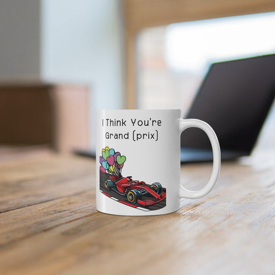 White ceramic mug with a colorful racing car illustration and the phrase &