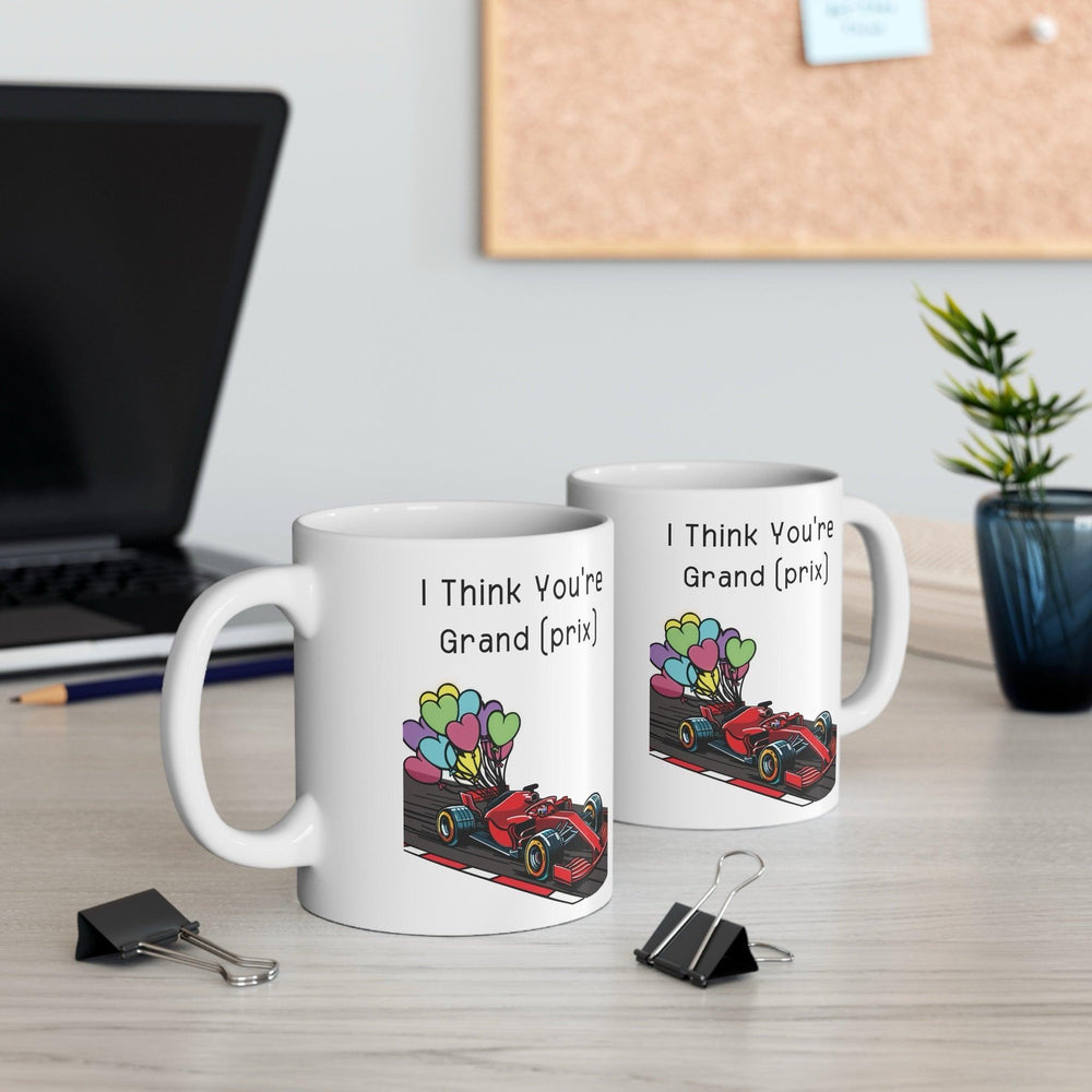 White ceramic mug with a colorful racing car illustration and the phrase 'I Think You're Grand Prix,' perfect for racing enthusiasts
