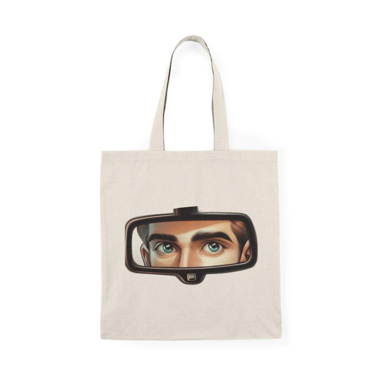 A natural tote bag adorned with a unique design featuring a rearview mirror and eyes peeking through. This intriguing graphic adds an element of mystery and style, making it a standout accessory for those who enjoy creative and artistic designs