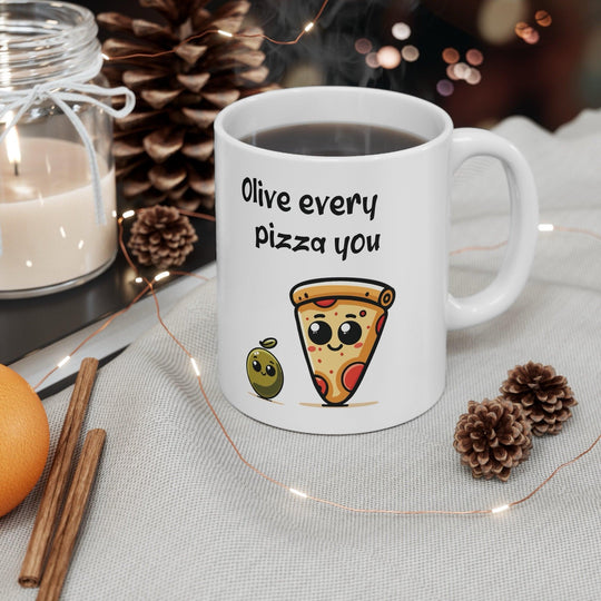 Cute white ceramic mug featuring a slice of pizza with the playful pun 'Olive Every Pizza You,' making it the perfect gift for pizza lovers.