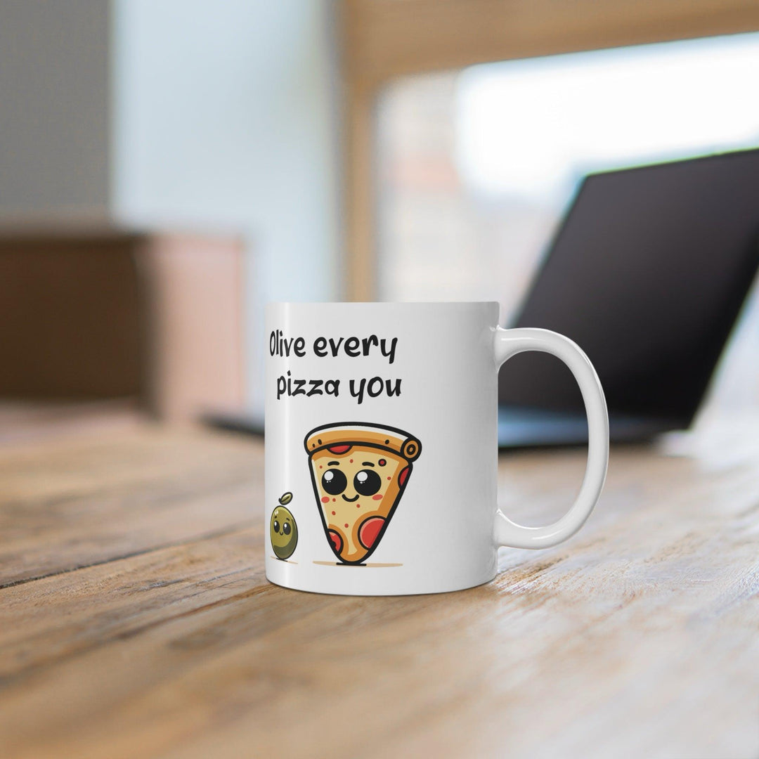Cute white ceramic mug featuring a slice of pizza with the playful pun 'Olive Every Pizza You,' making it the perfect gift for pizza lovers.