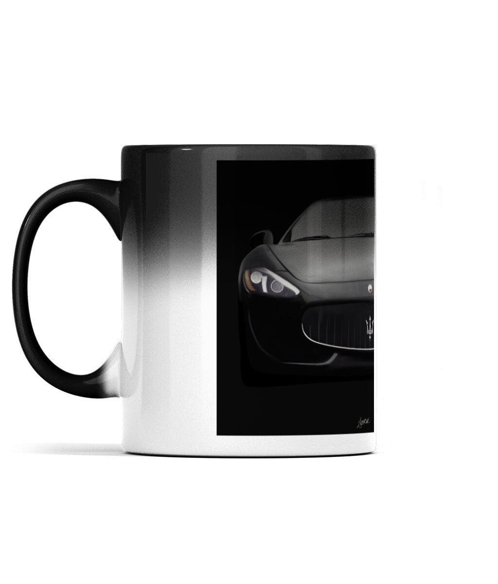Stylish black ceramic mug that reveals a Maserati car design when heated, perfect for luxury car enthusiasts who enjoy a touch of surprise with their coffee.