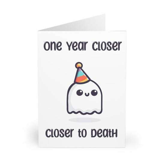 Funny and slightly dark birthday card featuring a smiling ghost in a party hat with the phrase 'One Year Closer to Death.' Ideal for friends with a morbid sense of humor who appreciate sarcastic cards - Baby Keo.