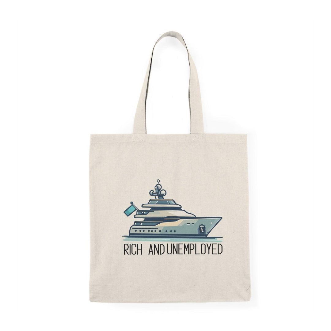 A cream-colored tote bag featuring a humorous design with the text 'Rich and Unemployed' alongside an illustration of a luxury yacht. This playful graphic contrasts wealth with unemployment, making it a fun accessory for those who appreciate irony.