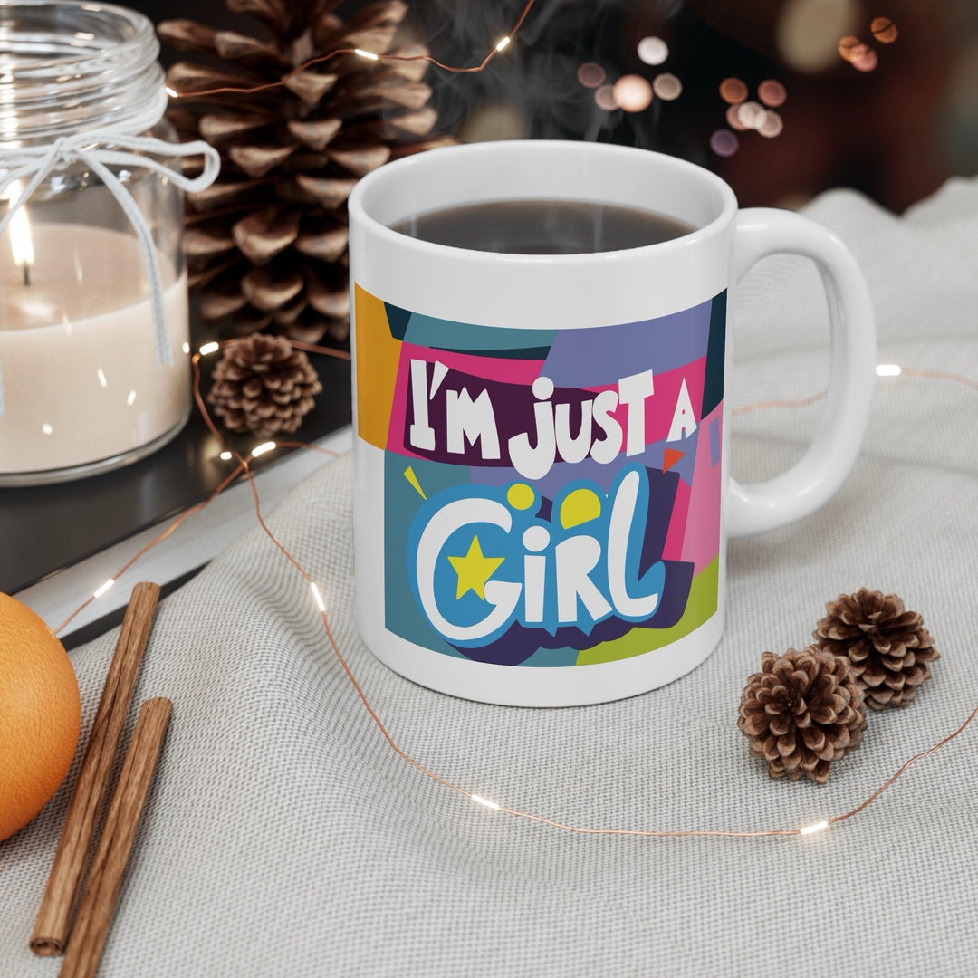 Colorful white ceramic mug with the bold and empowering text 'I'm Just a Girl,' perfect for showing off girl power in a stylish way