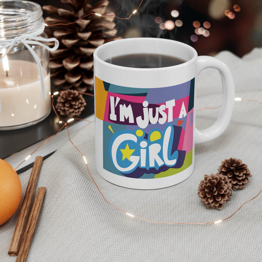 Colorful white ceramic mug with the bold and empowering text 'I'm Just a Girl,' perfect for showing off girl power in a stylish way
