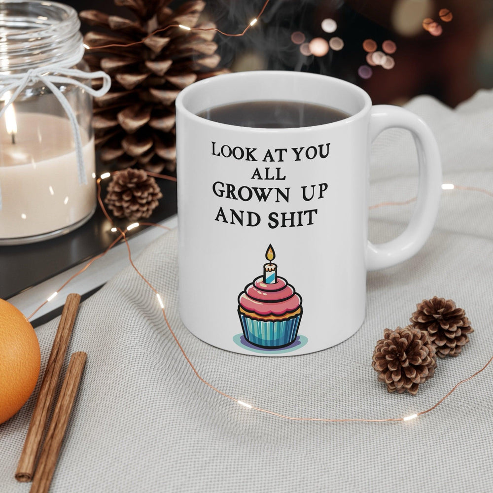 White ceramic mug featuring a cute cupcake illustration and the sassy phrase 'Look at You All Grown Up and Shit,' ideal for celebrating milestones with a cheeky twist.