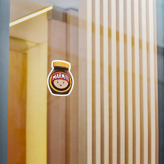 Fun waterproof sticker featuring a smiling Marmite jar with a face. Ideal for fans of this iconic spread, perfect for laptops, notebooks, or water bottles - Baby Keo
