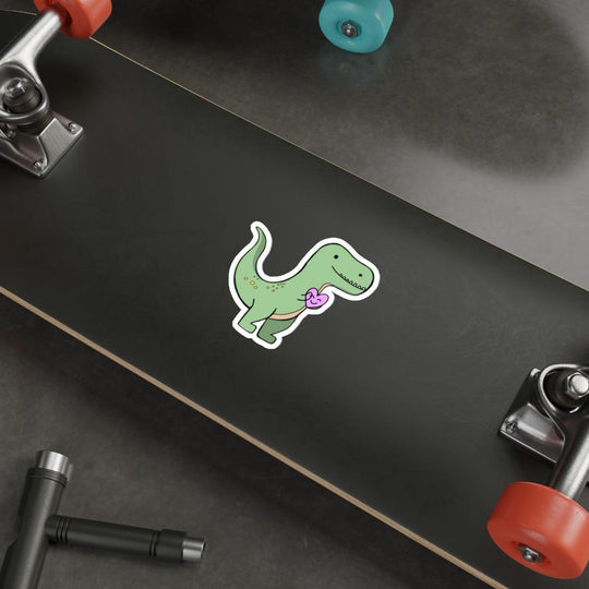 T-Rex Waterproof Sticker: A cute green T-Rex holding a pink heart, giving off adorable prehistoric vibes. Suitable for kids and dinosaur enthusiasts alike. KEOLIX 