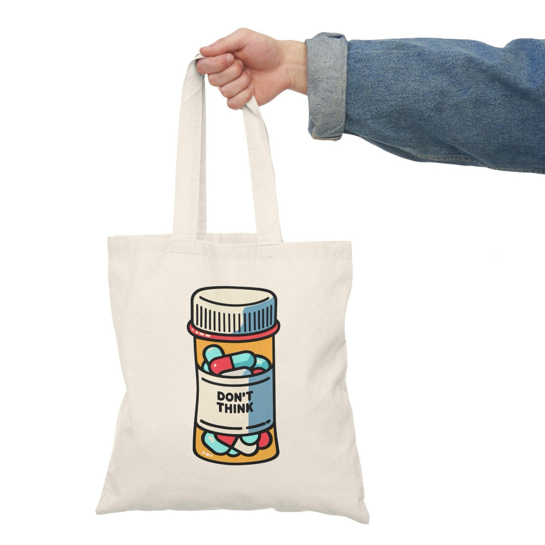 Tote bag featuring a humorous illustration of a pill bottle labeled 'Don't Think.' The playful design and bold colors create a lighthearted accessory, perfect for those who appreciate a fun take on mental health and self-care, making it a great addition to everyday carry.