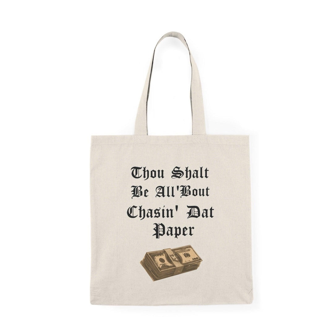 A cream tote bag featuring a stylish design with the phrase 'Thou Shalt Be All 'Bout Chasin' Dat Paper' in an eye-catching font. This fun and motivational message appeals to those who are ambitious and driven, adding a touch of humor to daily life