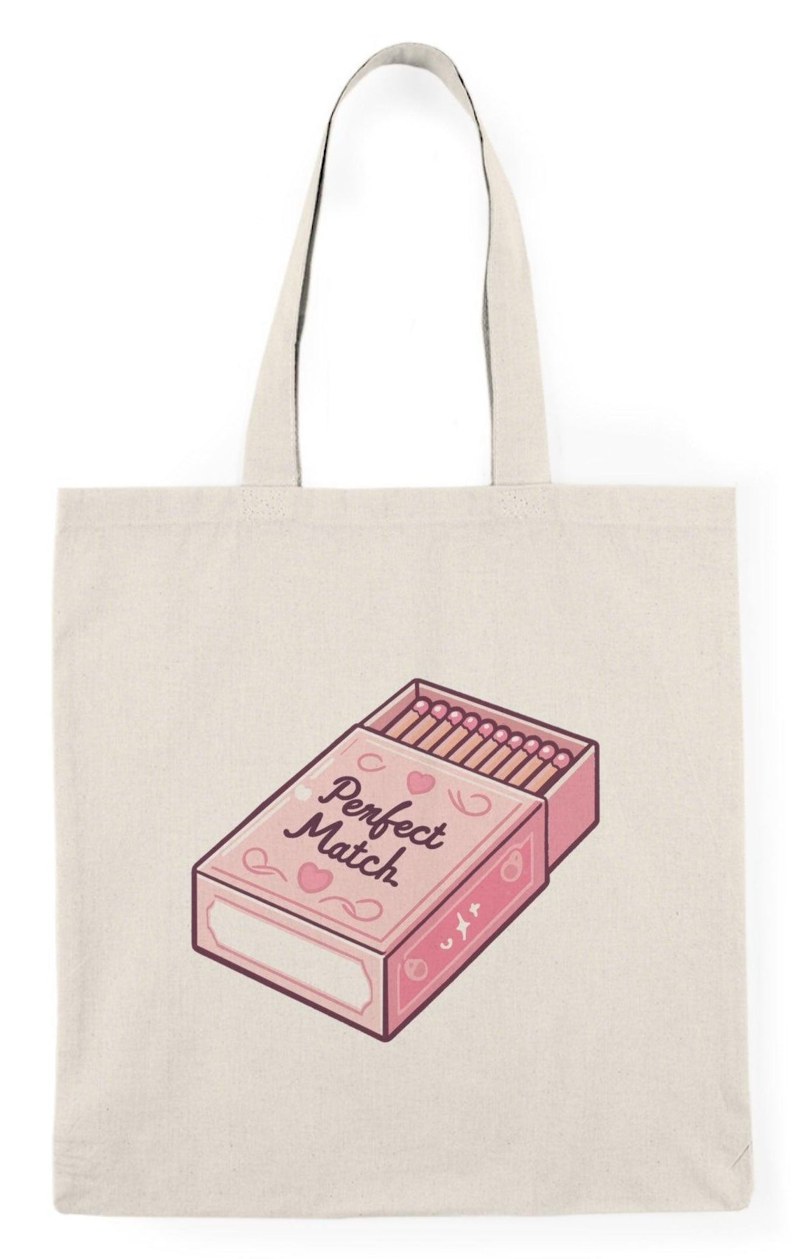 A cream tote bag featuring an artistic illustration of a matchbox with the phrase 'Perfect Match' written in a stylish font. The creative design gives a nod to love and connection, making it an ideal gift for couples or those who appreciate clever graphics