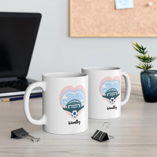 White ceramic mug with a design featuring Wembley stadium, ideal for fans of iconic British landmarks and events