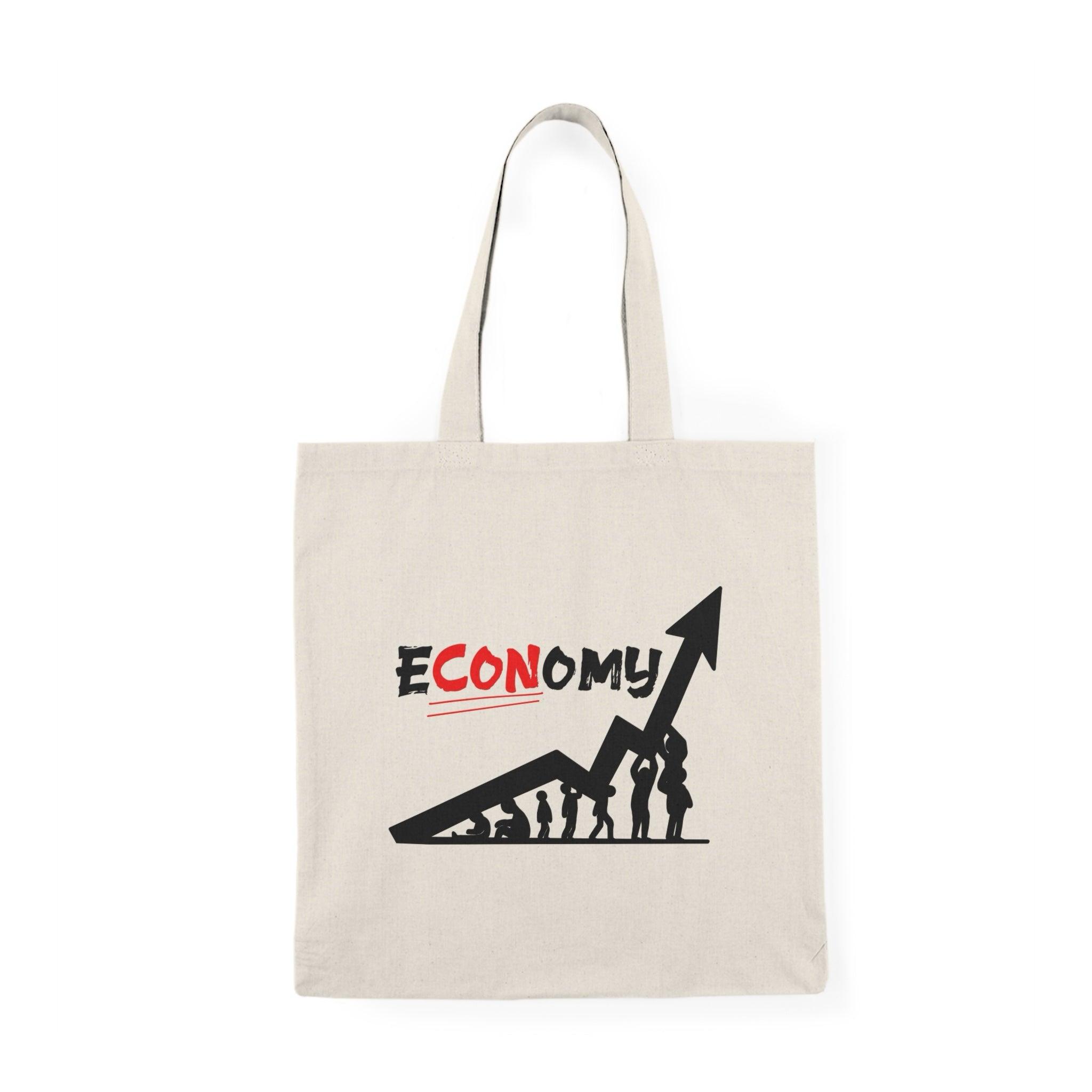 "Tote bag featuring a clever play on words with the phrase 'E-Con-omy,' creatively illustrated with vibrant colors and playful graphics. This humorous design adds a witty touch to your everyday carry, making it a perfect accessory for those who enjoy economics or appreciate a good pun."