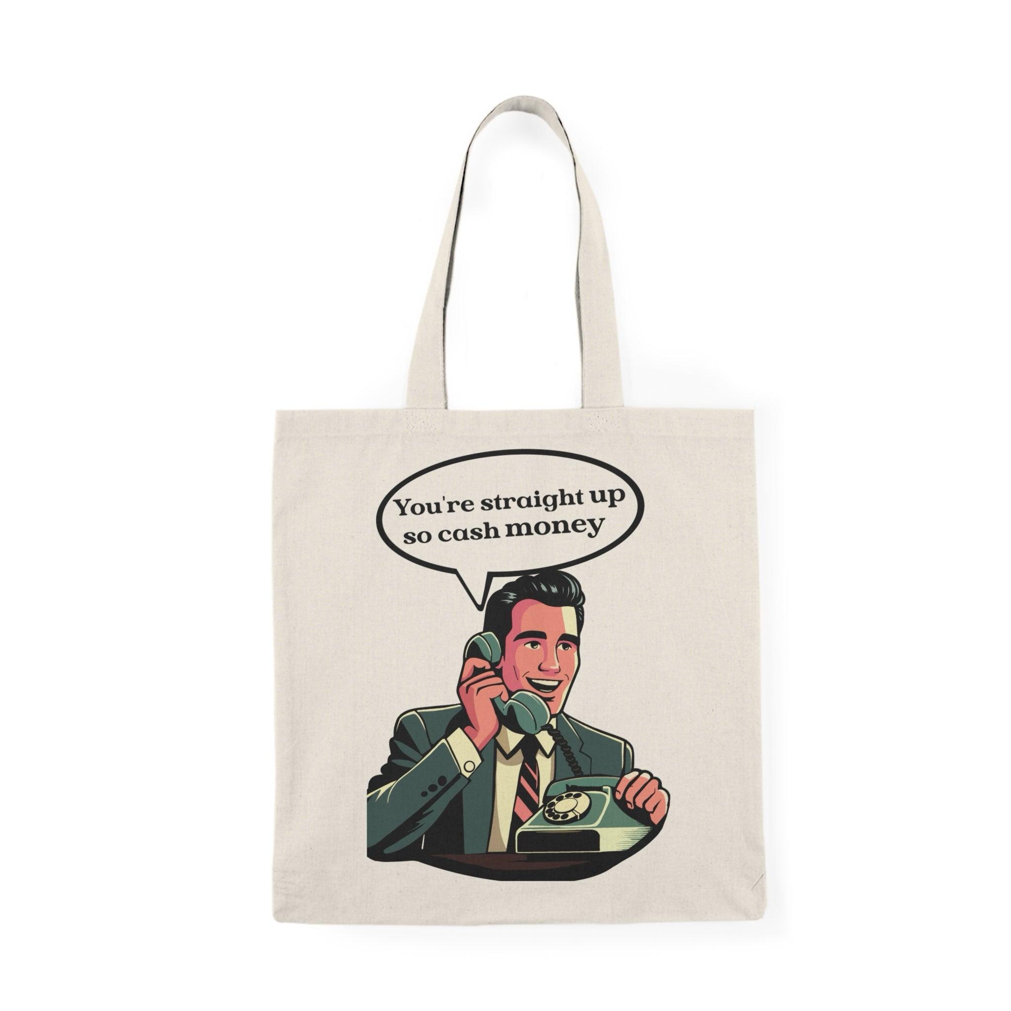 A natural canvas tote bag showcasing an illustration of a confident character holding cash with the phrase 'You're straight up so cash money.' This fun and upbeat design celebrates wealth and confidence, perfect for those who enjoy a playful take on finances.