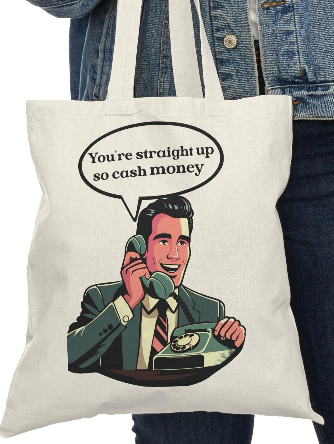 A natural canvas tote bag showcasing an illustration of a confident character holding cash with the phrase 'You're straight up so cash money.' This fun and upbeat design celebrates wealth and confidence, perfect for those who enjoy a playful take on finances.