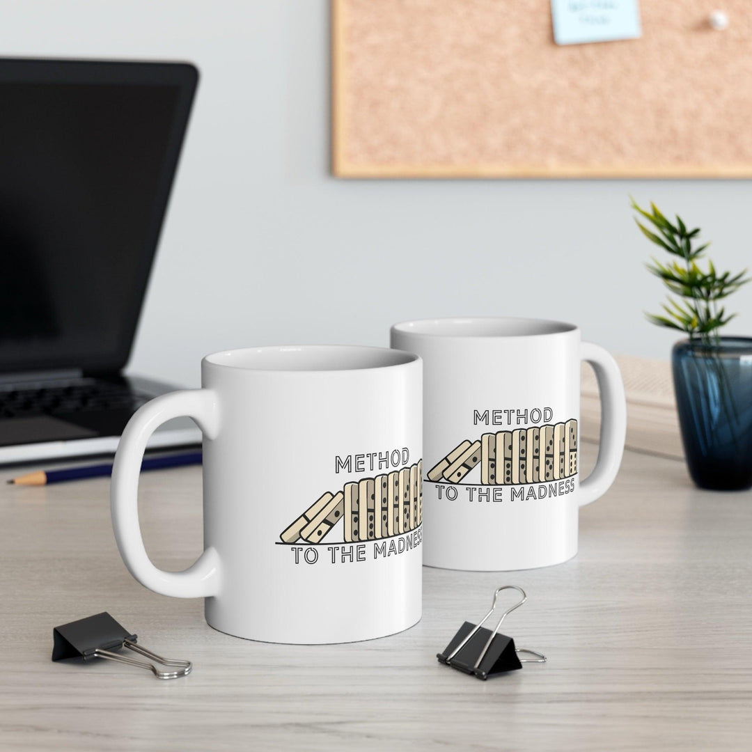 White ceramic mug featuring a book spine illustration with the phrase &
