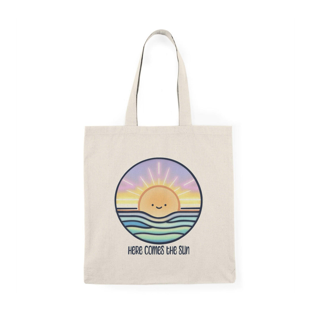 Tote bag featuring a cheerful illustration of a bright sun with a smiling face, surrounded by vibrant rays and colorful elements. The uplifting design embodies positivity and warmth, making it a perfect accessory for sunny days or adding a bright touch to your everyday carry.