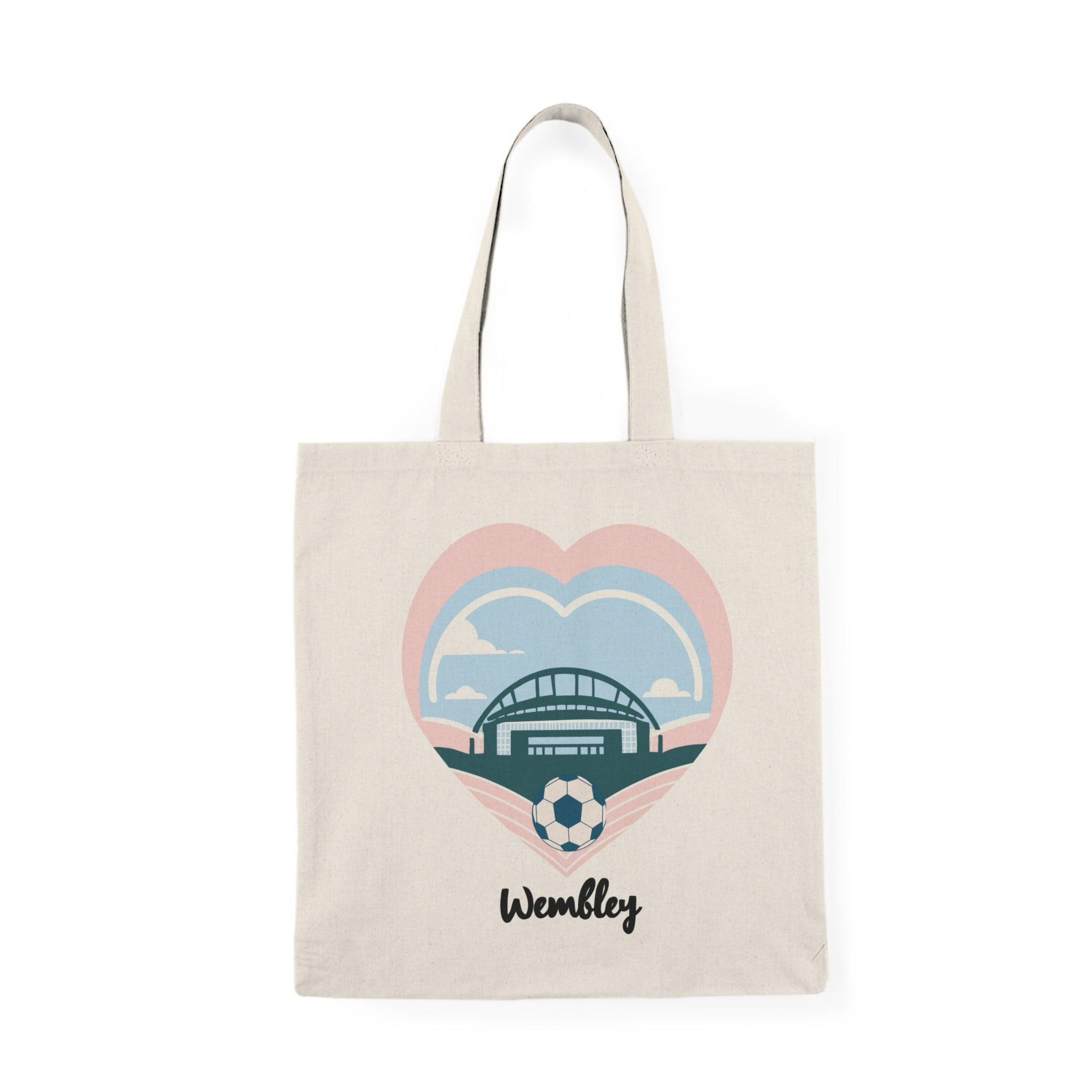 A natural tote bag featuring a graphic illustration of the iconic Wembley Stadium, surrounded by heart motifs. This design celebrates the spirit of the venue, making it a perfect accessory for sports fans and music lovers alike