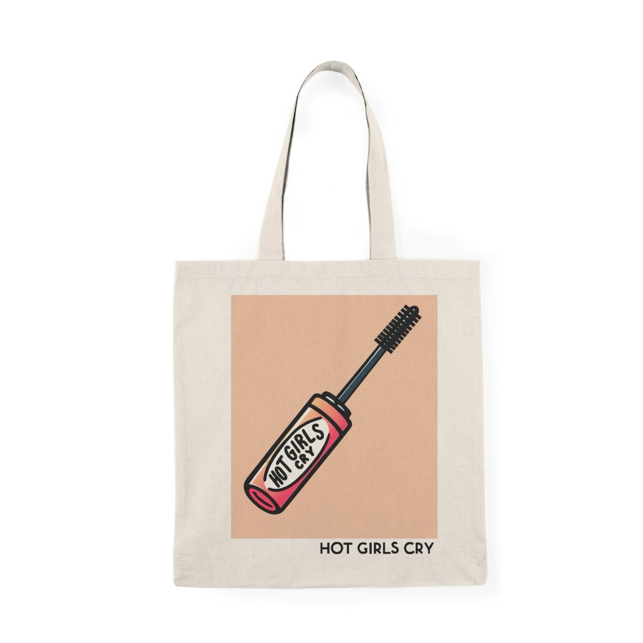 Tote bag featuring a bold and playful design with the phrase 'Hot Girls Cry' in eye-catching typography. The vibrant colors and striking graphics convey a message of empowerment and vulnerability, making it a perfect accessory for those who embrace their emotions while adding a stylish touch to their everyday carry.