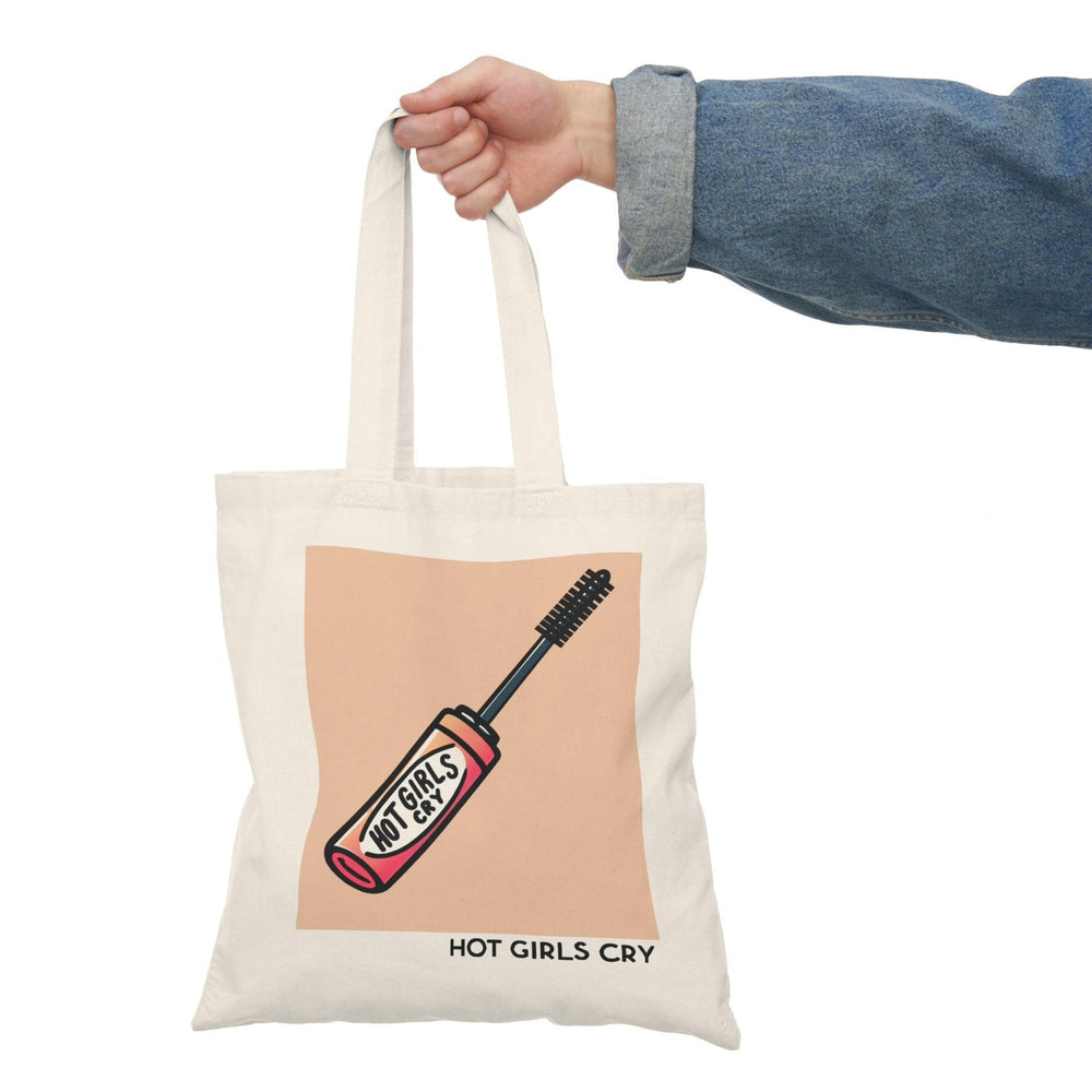 Tote bag featuring a bold and playful design with the phrase 'Hot Girls Cry' in eye-catching typography. The vibrant colors and striking graphics convey a message of empowerment and vulnerability, making it a perfect accessory for those who embrace their emotions while adding a stylish touch to their everyday carry.
