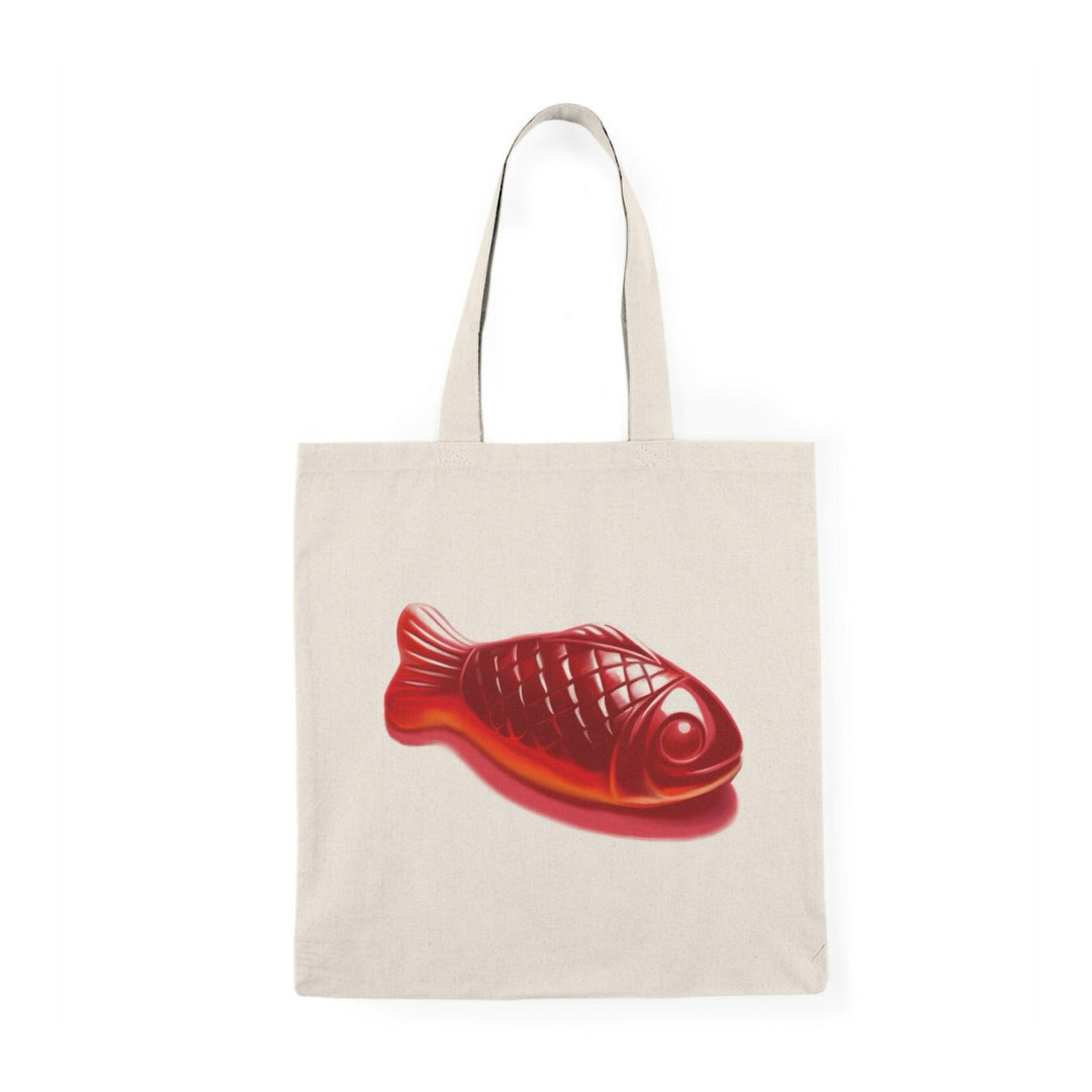 Eco-friendly canvas tote bag featuring a bright red Swedish Fish candy illustration. Perfect for grocery runs, casual outings, or as a fun gift for candy lovers - Baby Keo.