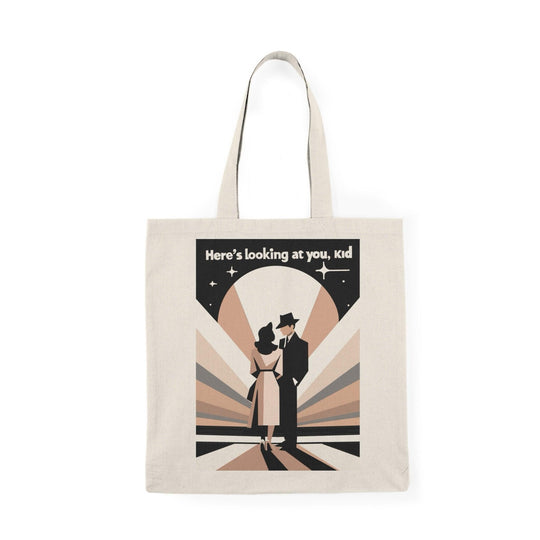 Stylish canvas tote bag featuring a vintage-inspired design with a figure in a suit and the quote 'Here’s Looking at You Kid' in black and white. A perfect tote for movie lovers or vintage enthusiasts - Baby Keo