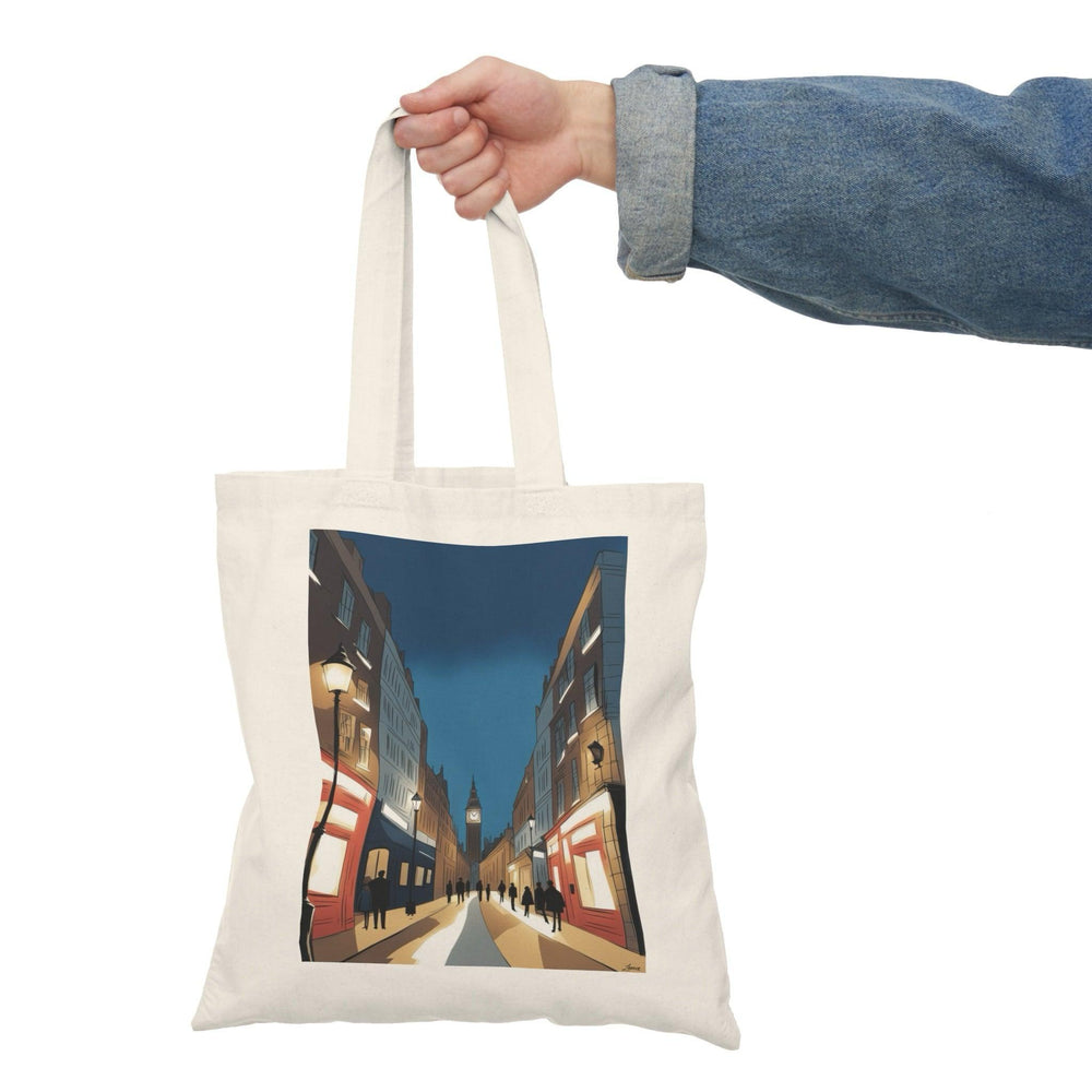 A cream-colored tote bag showcasing a stunning photographic print of a vibrant London nightscape, featuring illuminated buildings and streets. This eye-catching design captures the essence of city life at night, perfect for those who love urban exploration