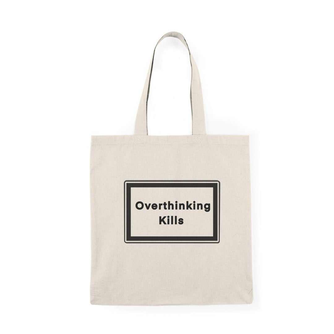 A natural canvas tote bag with a bold and straightforward message: 'Overthinking kills' displayed prominently in a black rectangular box. The minimalist design effectively conveys a powerful reminder about the effects of excessive thought and stress.