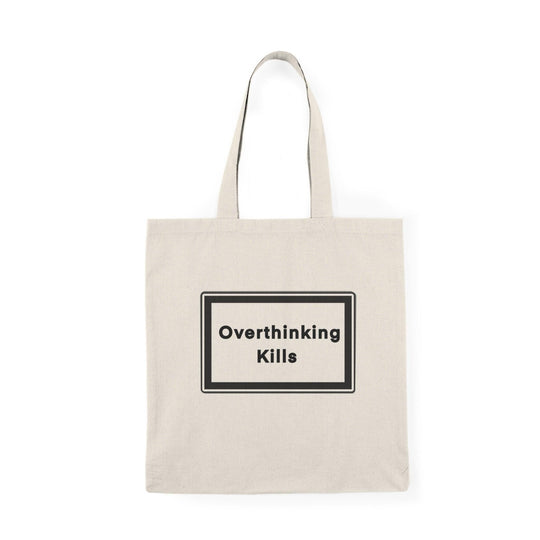 A natural canvas tote bag with a bold and straightforward message: 'Overthinking kills' displayed prominently in a black rectangular box. The minimalist design effectively conveys a powerful reminder about the effects of excessive thought and stress.