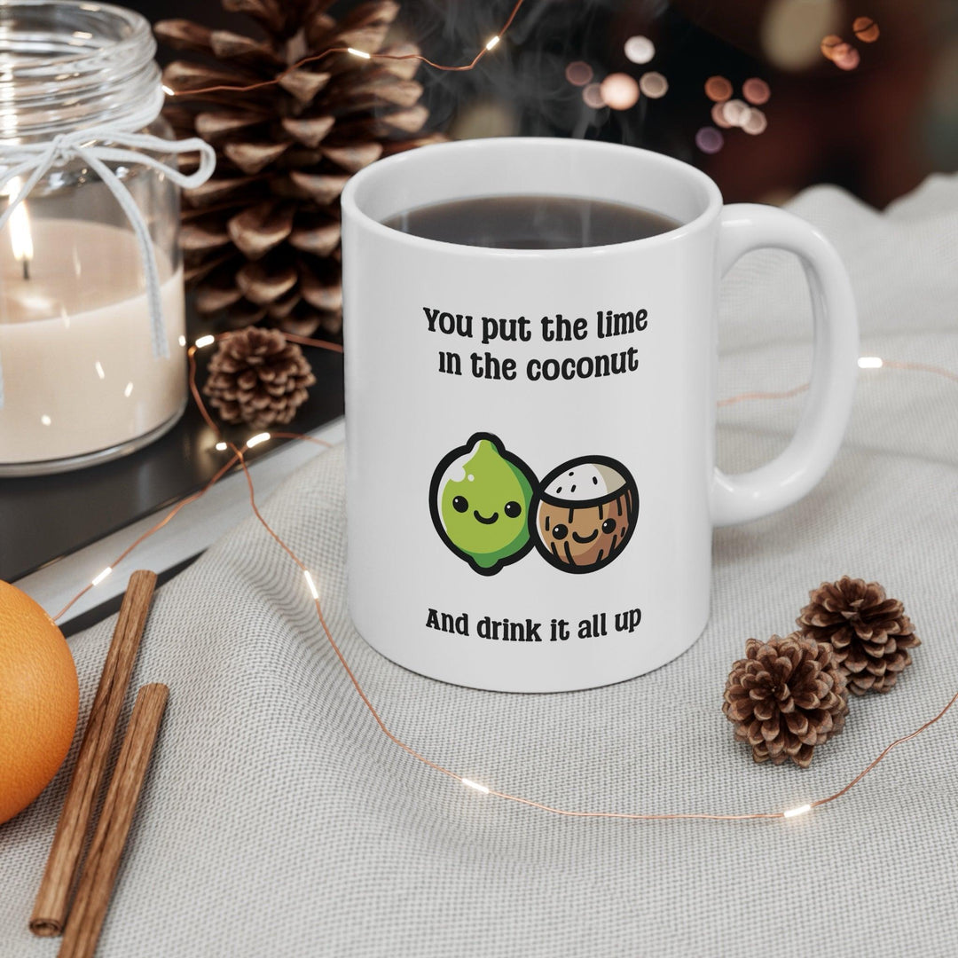 Fun ceramic mug featuring a cheerful lime and coconut illustration with the phrase 'You put the lime in the coconut and drink it all up.' A quirky gift or perfect addition to your morning coffee routine - Baby Keo.