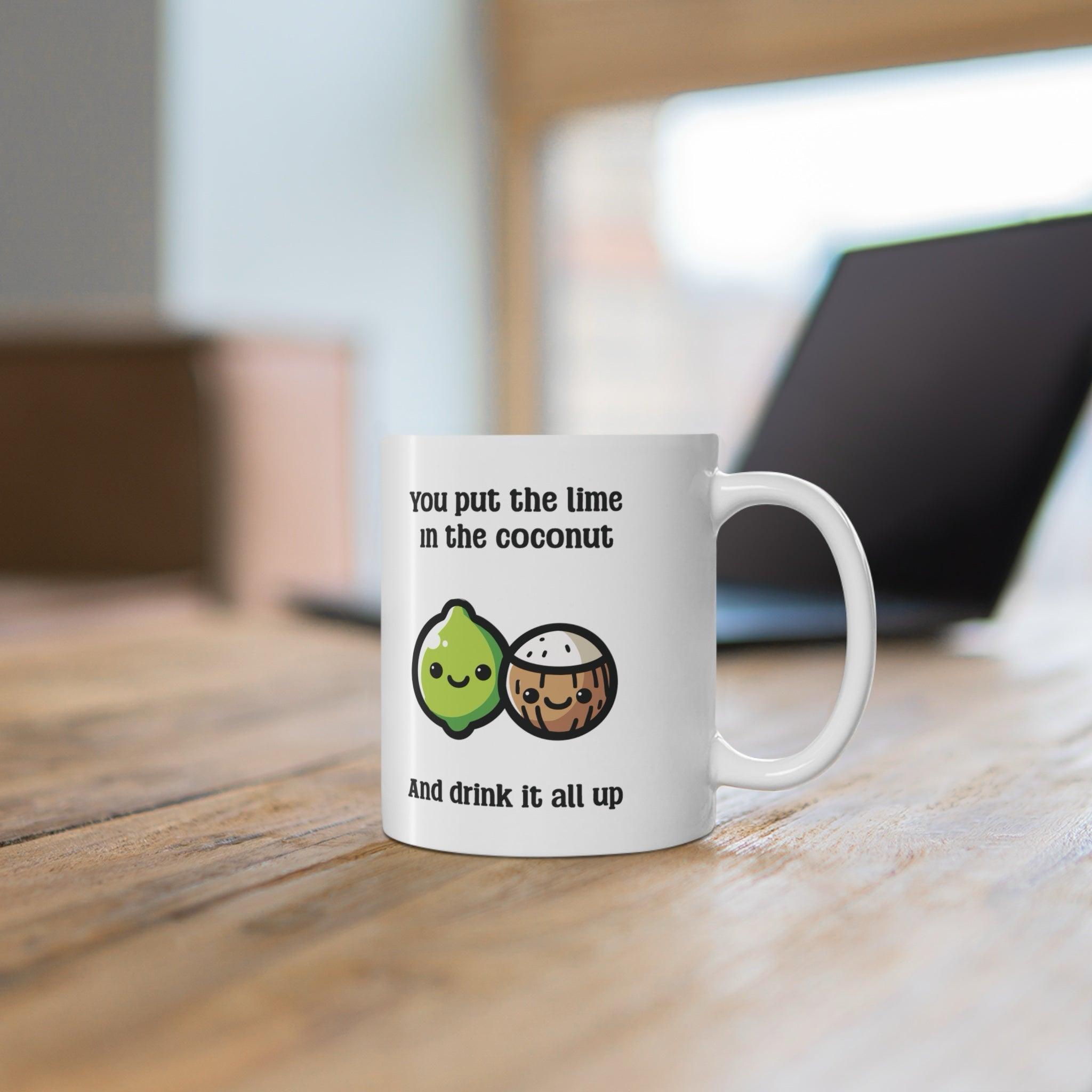Fun ceramic mug featuring a cheerful lime and coconut illustration with the phrase 'You put the lime in the coconut and drink it all up.' A quirky gift or perfect addition to your morning coffee routine - KEOLIX 