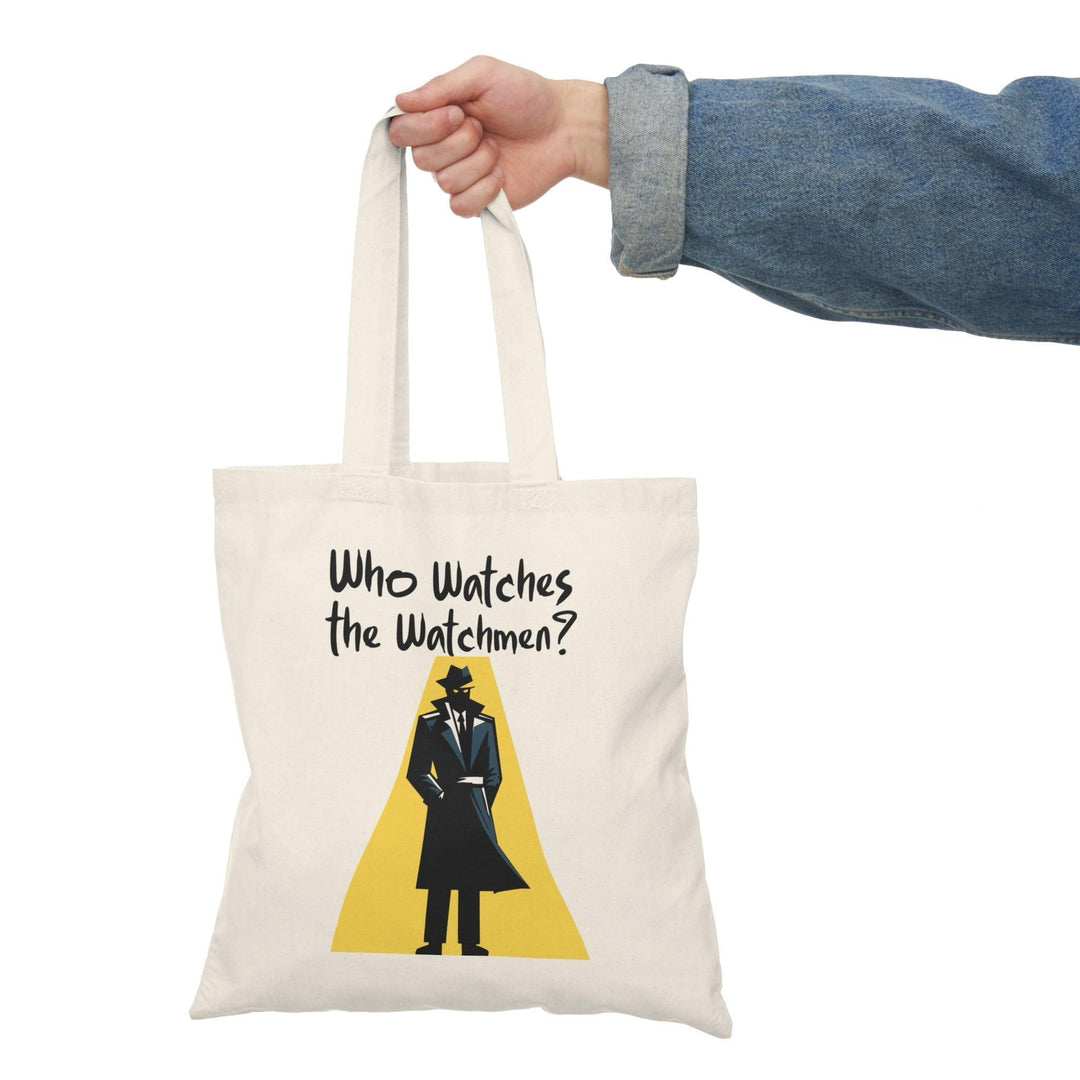 A cream-colored tote bag featuring an illustration of a person in a suit and tie, looking at a watch, with the text 'Who Watches the Watchmen?' The design plays on themes of vigilance and oversight, making it a thought-provoking accessory for fans of literature and pop culture