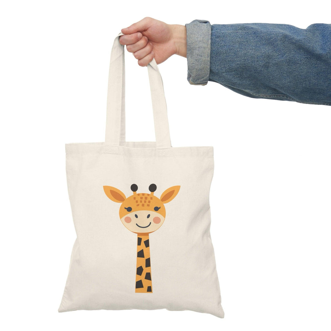 Tote bag featuring a whimsical illustration of a giraffe with a playful expression, set against a colorful background. The vibrant design captures the unique charm of this majestic animal, making it a perfect accessory for animal lovers and a fun way to carry your everyday essentials."

