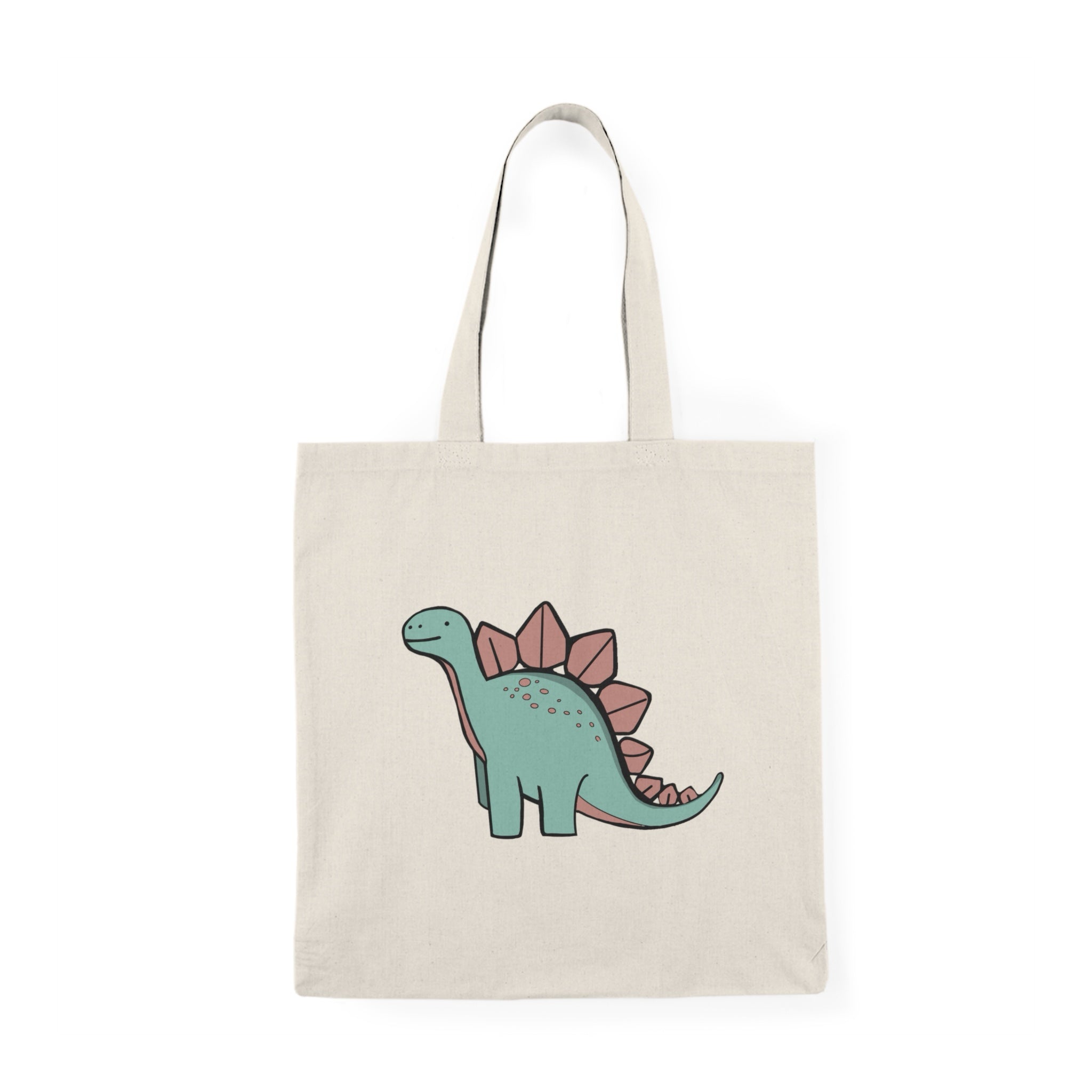 Tote bag featuring a fun and colorful illustration of a cheerful dinosaur, complete with vibrant scales and a playful expression. The whimsical design adds a touch of prehistoric charm, making it an ideal accessory for dinosaur enthusiasts and anyone looking to express their playful personality in everyday carry."