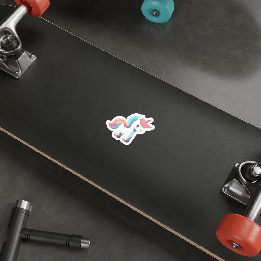 A cartoon unicorn sticker in pastel colors affixed to the side of a laptop, with a keyboard and a mouse in the background on a wooden desk.