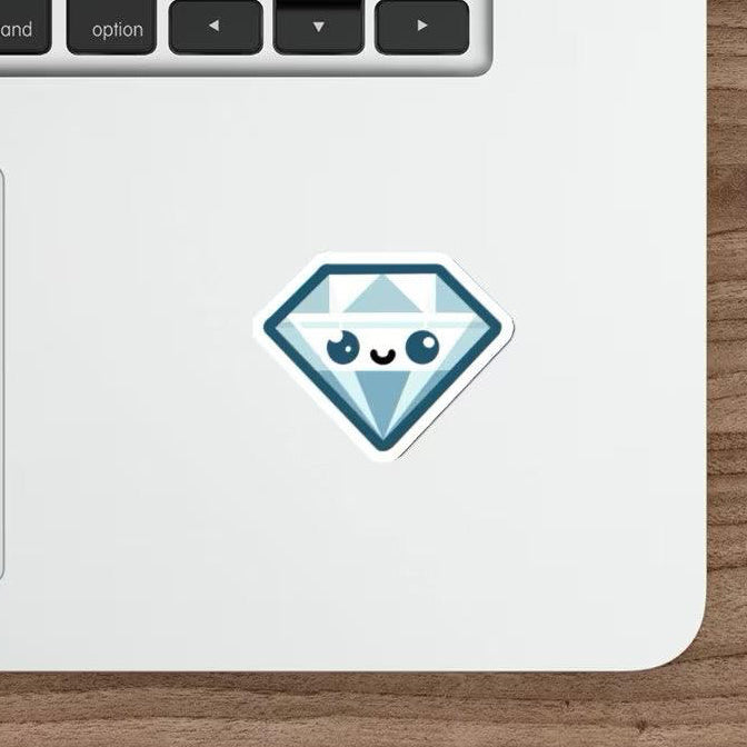 A blue diamond cartoon sticker with a cute face pasted on a laptop next to a computer mouse on a wooden desk.