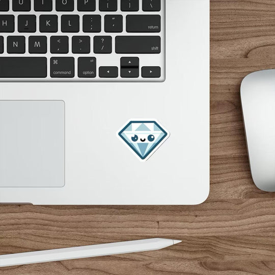 A blue diamond cartoon sticker with a cute face pasted on a laptop next to a computer mouse on a wooden desk.