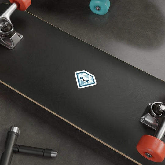 A blue diamond cartoon sticker with a cute face pasted on a laptop